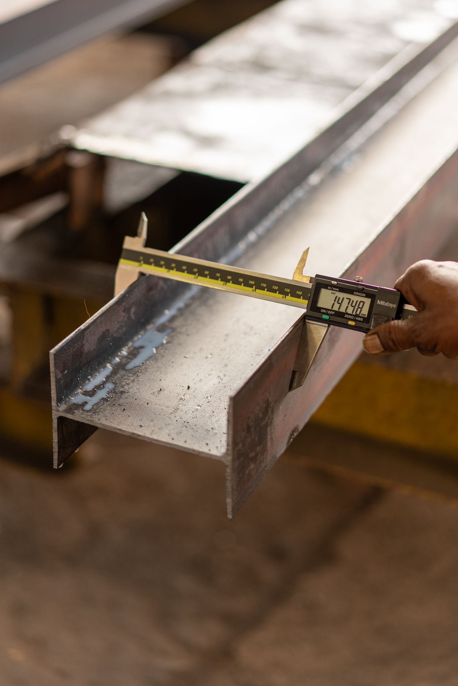 digital caliper measuring the width of a metal profile.jpeg