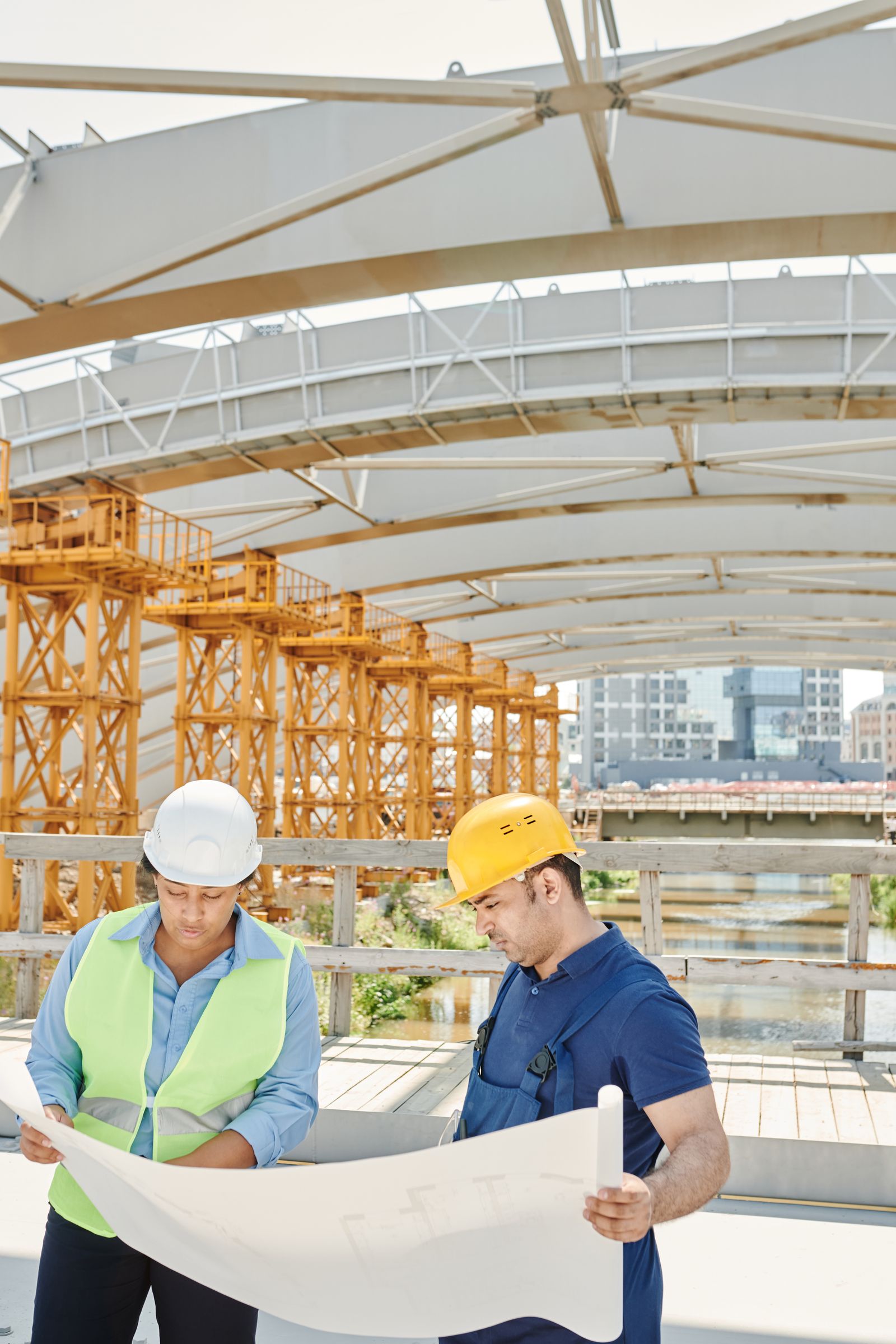 engineers checking a blueprint against the structure on site.jpeg